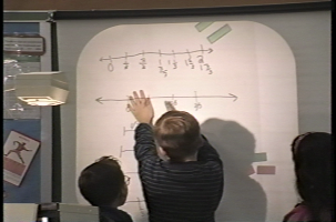 3 students sketch their perfect set of rods on a whitebboard